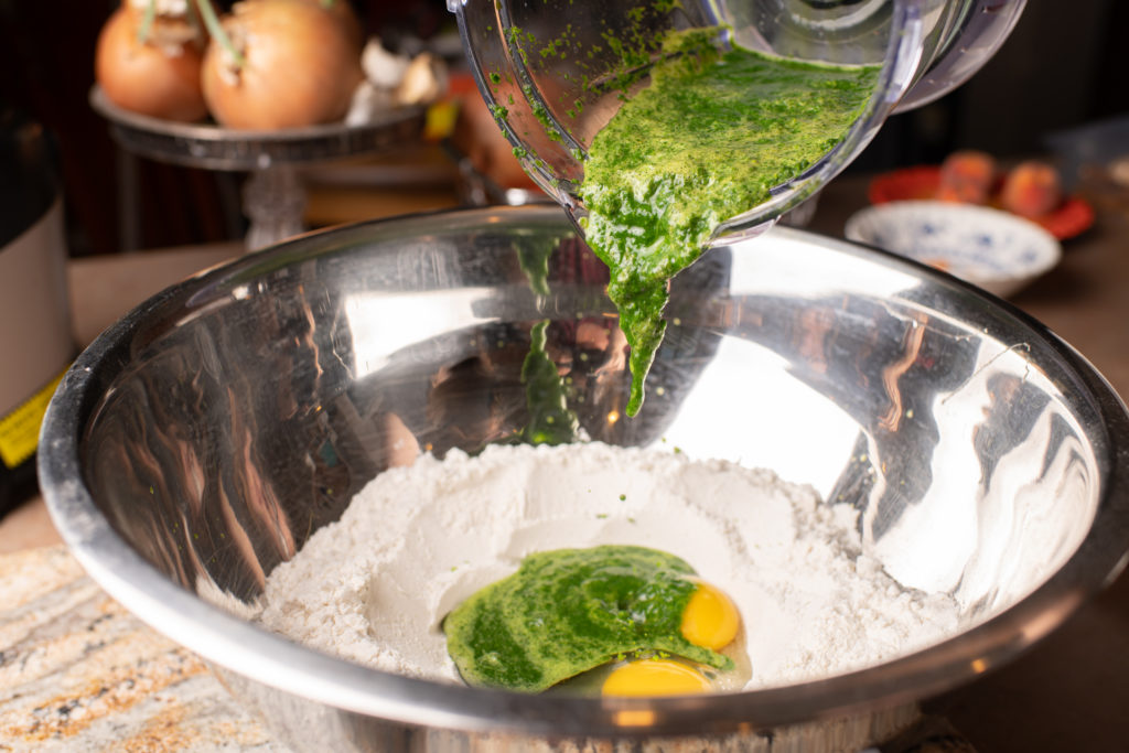 Add the moringa puree to the egg and flour mix.